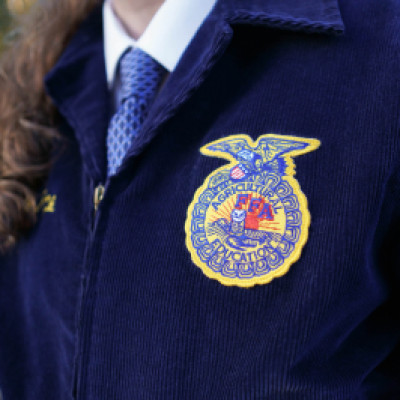 Close up of patch on person's jacket with Agricultural FFA Education written on it with a logo