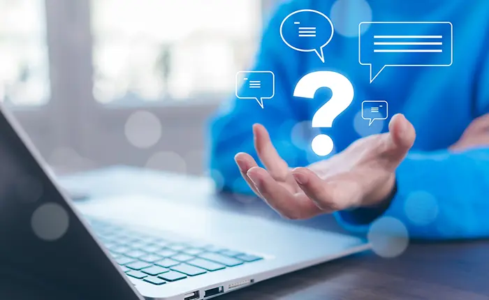 person on laptop with questions