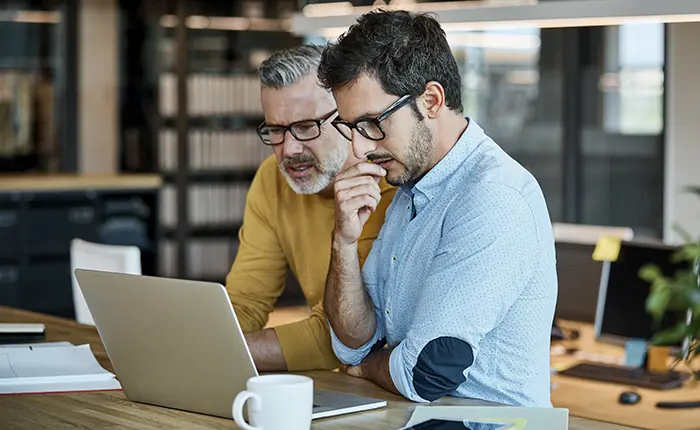 business men looking at laptop