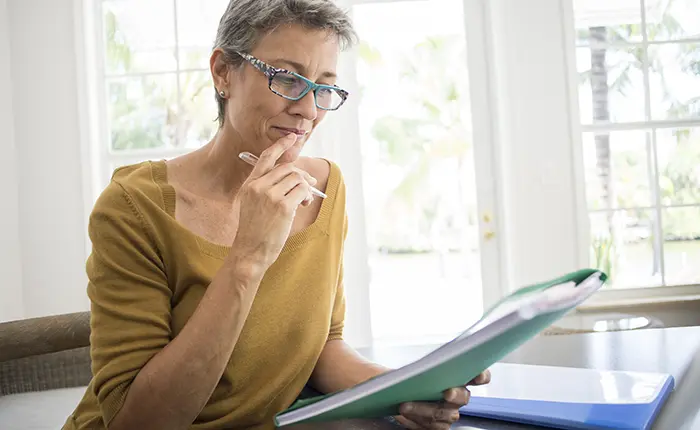 woman looking over paperwork