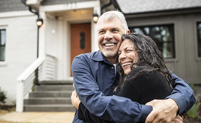 couple in front on new home