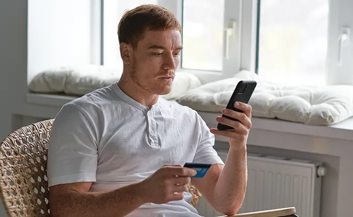 man paying on line with a credit card